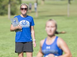 Head KCC Cross-Country Coach Erin Lane watches a runner finish at the Knight-Raider Invitational in Grand Rapids in 2019.