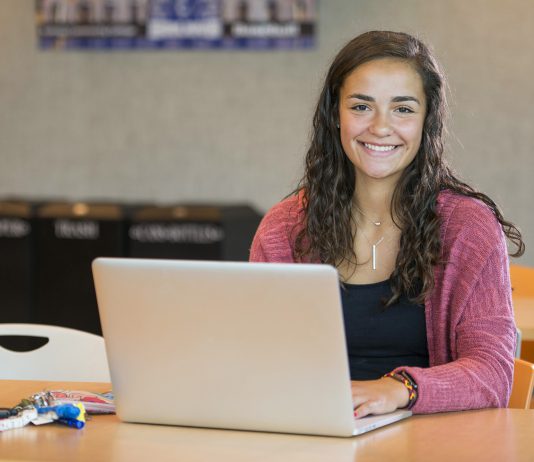A student works on a laptop in the Student Center.