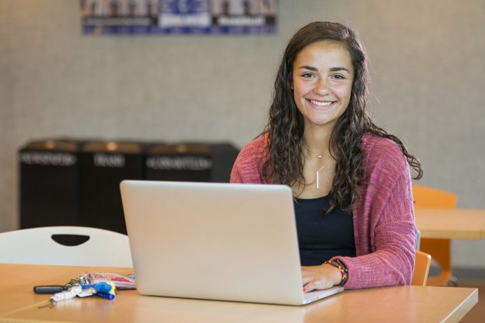 A student works on a laptop in the Student Center.